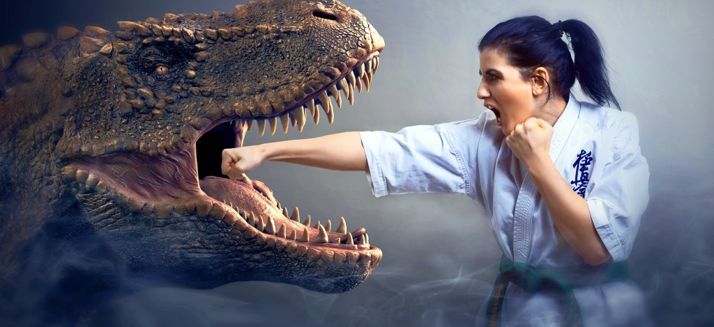 Woman martial artist punching a T-Rex in the mouth